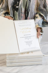 Elegant wedding invitation in luxury box embossed with gold foil